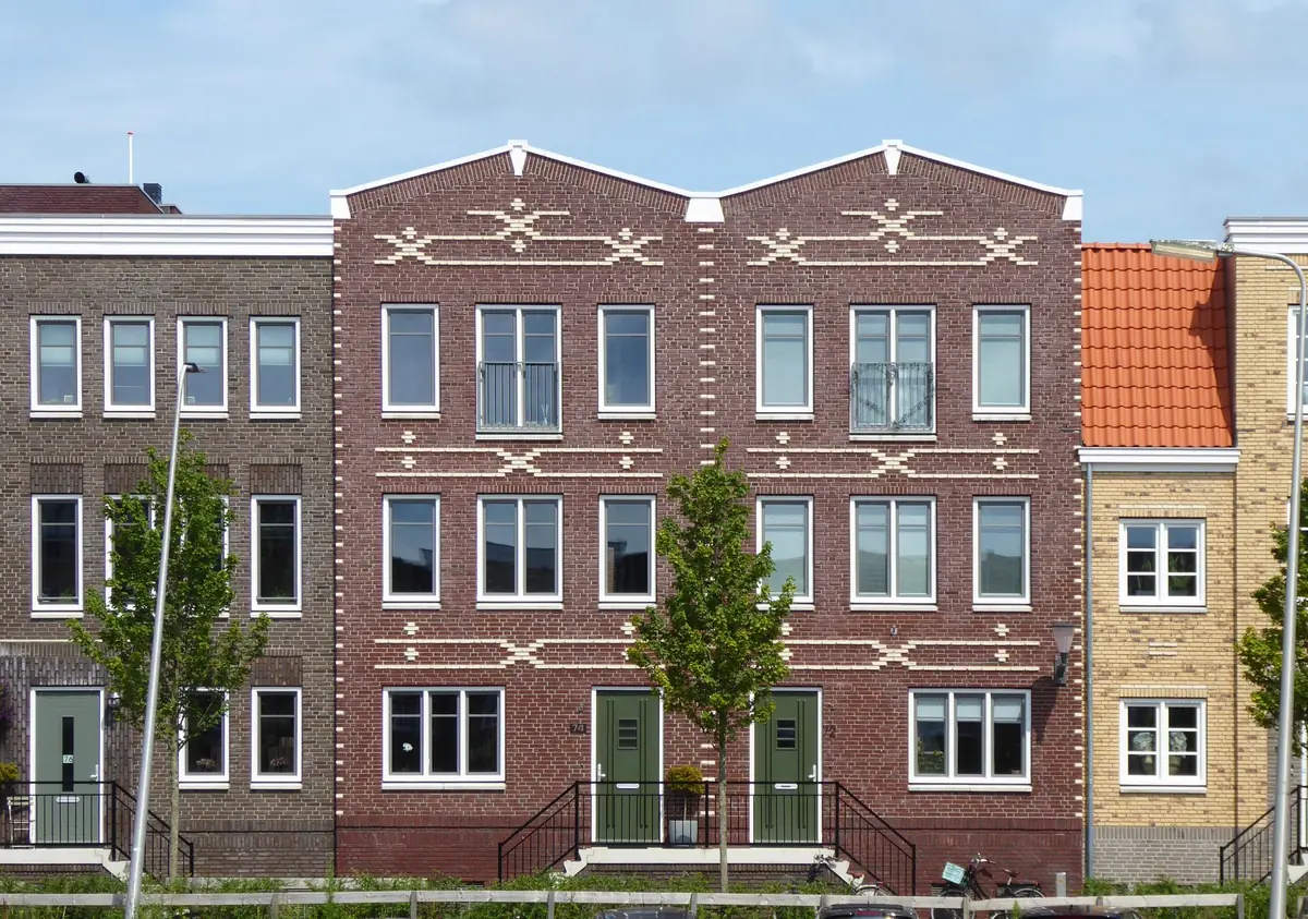 A row of tall brick residential buildings with repeating window bays.
